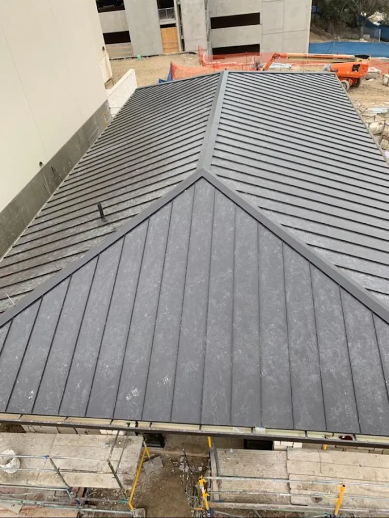 Commercial metal roof construction with crane equipment in Chickasha