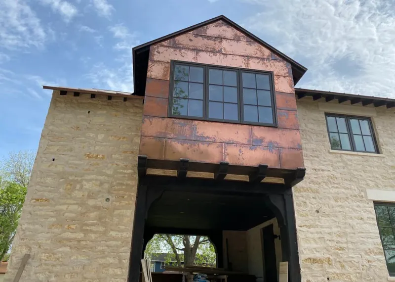 Copper metal panel facade on a stone building for Metal Roof Coating in Chickasha