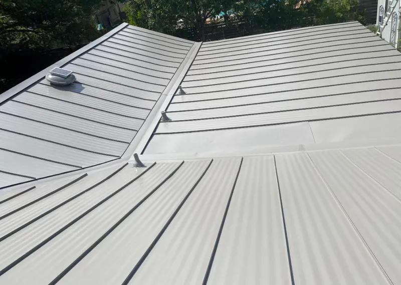 Solar attic fan installed on a metal roof for Roof Ventilation in Chickasha
